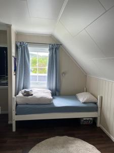 a small bed in a room with a window at Kronstad in Alta