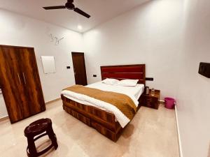 a bedroom with a bed and a ceiling fan at ramraz residency in Ayodhya