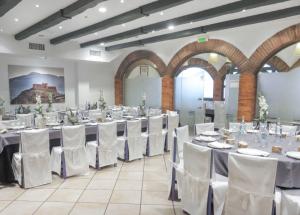 a banquet hall with white tables and white chairs at Hotel Virrey in Arnedo