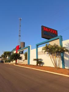 a building with a sign on the side of a street at Motel Marajas Mococa - Apartamento 23 in Mococa +6 photos