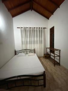 a bedroom with a white bed and a window at CFR SkyLine in Katunayaka