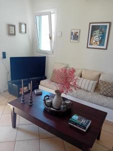 a living room with a coffee table and a couch at Aethalios katoikia in Korissia
