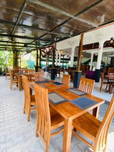 a wooden table and chairs in a restaurant at CFR SkyLine in Katunayaka