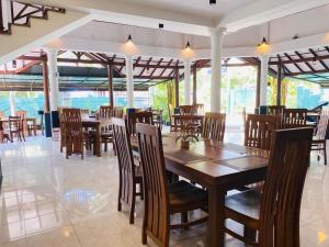 a dining room with wooden tables and chairs at CFR SkyLine in Katunayaka