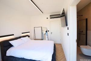 a bedroom with a white bed and a bathroom at Ville delle luci in Tefahot +25 photos