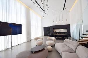 a living room with a couch and chairs and a piano at Ville delle luci in Tefahot
