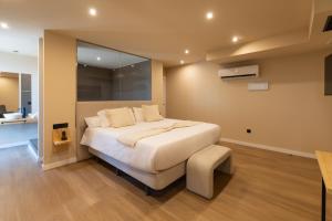 a bedroom with a large bed in a room at Arena Málaga Suites in Málaga
