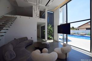 a living room with a couch and chairs and a tv at Ville delle luci in Tefahot