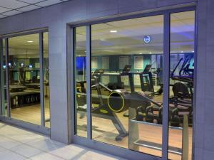 a gym with several treadmills in a building at Mercure Lyon Centre Saxe Lafayette in Lyon