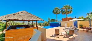 a patio with a pool and a table and chairs at Villa Evora in Moraira