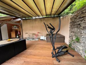 a fitness room with a gym with a treadmill at La halte du Clos in Souvigny