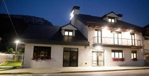 a white house with lights on top of it at Apartamentos Canto Encaramado in Gibaja