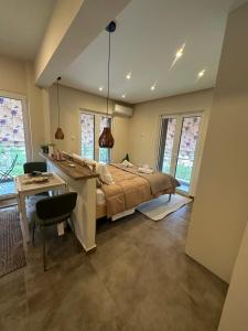 a bedroom with a bed and a desk in it at Kyma Boutique Suite in Nea Makri
