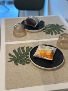 a table with two plates of food on it at Kyma Boutique Suite in Nea Makri