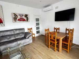 a living room with a couch and a table at La Villa Toledana in Cabañas de la Sagra +43 photos