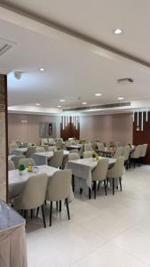 a dining room with tables and chairs in a restaurant at Burj Al Balad Hotel in Mecca