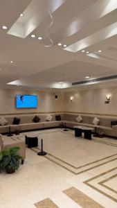 a lobby with couches and a flat screen tv at Burj Al Balad Hotel in Mecca