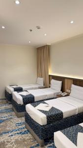 a row of beds in a room at Burj Al Balad Hotel in Mecca