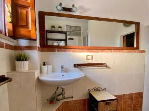 a bathroom with a sink and a mirror at Casa Mare Holiday Pozzallo in Pozzallo +82 photos
