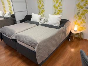 a large bed in a room with a table at Apartment Komin in Komín