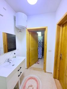 a bathroom with a sink and a mirror at Résidence Azur Djerba in Taguermess