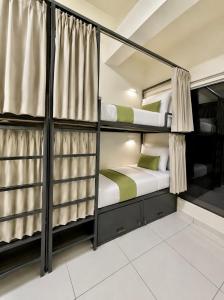 a bunk bed room with two bunk beds at VELORA DORMs in Ujjain
