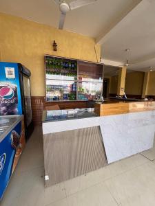 a restaurant with a counter with a drink cooler at Hotel Keshav Palace in Mahwah