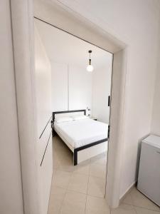 a bedroom with a bed in a white room at Seaview Radhime in Vlorë