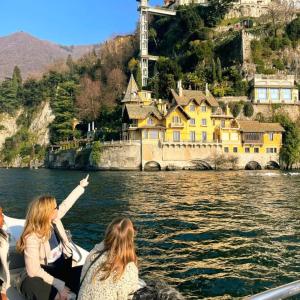 a group of people on a boat on the water at Como Lake - Balcony, Private Parking, 2 Bathrooms in Cernobbio