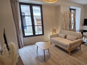a living room with a couch and a table at Klass Loft Kemperle in Quimperlé