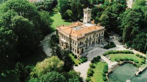 an aerial view of a building with a tower on top at Como Lake - Balcony, Private Parking, 2 Bathrooms in Cernobbio
