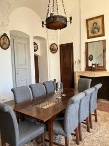 a dining room with a wooden table and chairs at Chateau d Albon - Catherine de Medicis in Saint-André-dʼApchon +21 photos