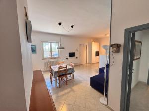 a living room with a table and a dining room at casa villa degli ulivi in Colonnella