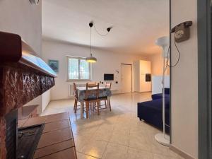 a living room with a table and a dining room at casa villa degli ulivi in Colonnella