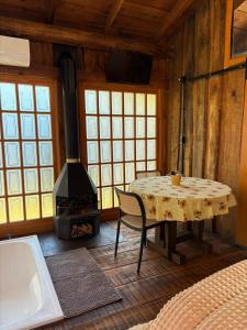 a dining room with a table and a stove at Chalé Do Lago in Garibaldi