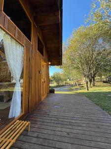 a porch of a wooden building with a window at Chalé Do Lago in Garibaldi +13 photos