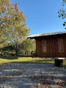 a log cabin with a gravel path in front of it at Chalé Do Lago in Garibaldi