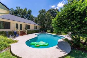 a swimming pool with a green toy in the middle at Coastal Lane - Entire in Jacksonville