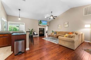 a living room with a couch and a kitchen at Coastal Lane - Entire in Jacksonville