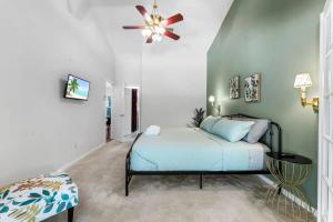 a bedroom with a bed and a ceiling fan at Coastal Lane - Entire in Jacksonville +56 photos