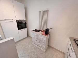 a kitchen with a counter with a microwave and a stove at casa villa degli ulivi in Colonnella +22 photos