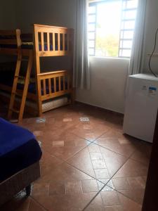 a room with a tiled floor with a window and a refrigerator at ECO BROTAS Pousada e Rafting in Brotas