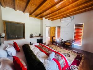 a bedroom with a large bed with red pillows at Arhat Resort in Deskit