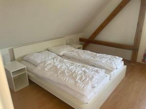 a white bed with white sheets and pillows at Haus Mediterran in Kamień Pomorski +34 photos