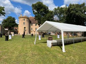 a white tent in front of a castle at Chateau d Albon - Catherine de Medicis in Saint-André-dʼApchon