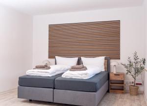 a bed with two pillows on it in a room at Casa Materi Schweinfurt in Schweinfurt