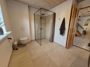 a bathroom with a shower with a glass shower stall at Tranum B&B in Brovst +15 photos