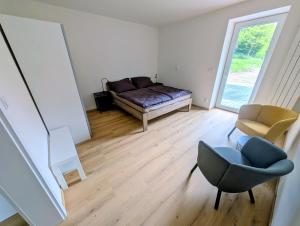 a living room with a couch and a chair at Apartmány v Propadání in Jedovnice