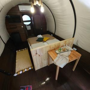 a room with a bed and a table in a tent at Várlak Glamping in Sub Cetate +13 photos