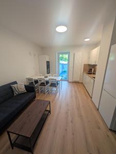a living room with a couch and a table at Apartmány v Propadání in Jedovnice